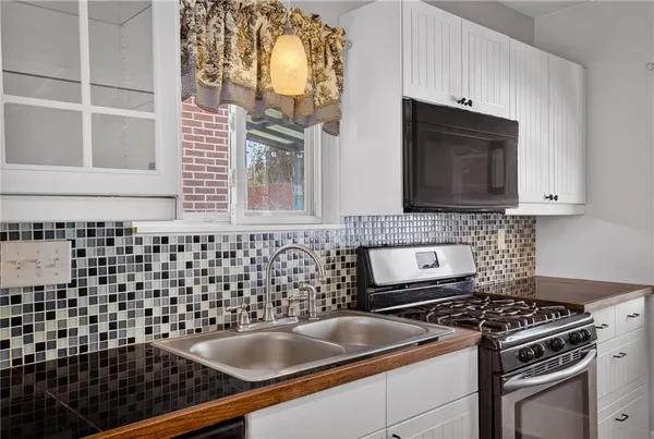 a kitchen with granite countertop a stove and a sink