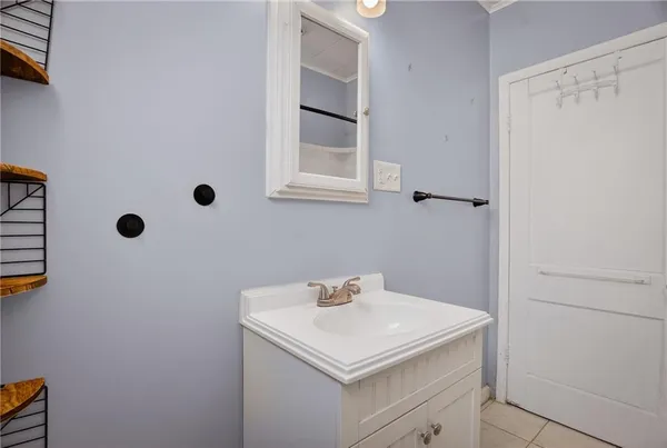 a bathroom with a sink a vanity and a mirror