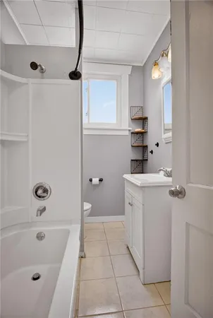 a bathroom with a sink a vanity and tub