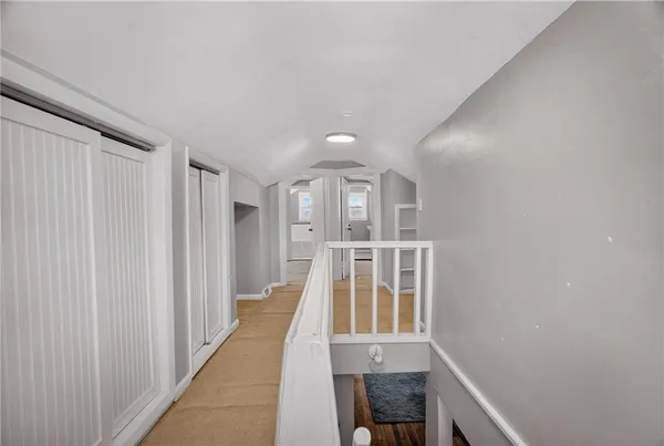 a view of entryway with wooden floor and stairs