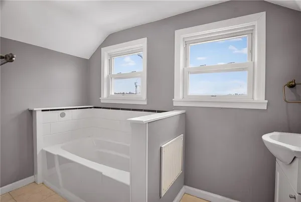 a bathroom with a bathtub and a window