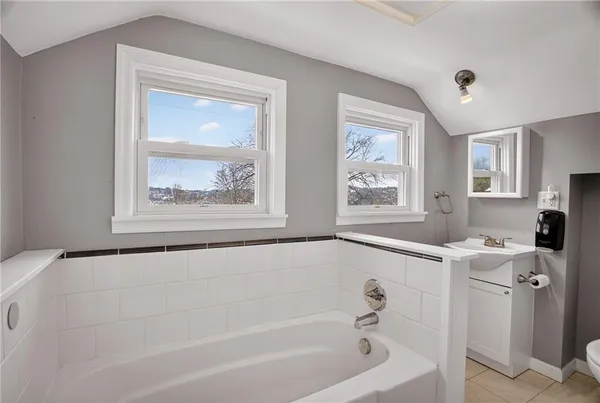 a bath tub sitting next to a window