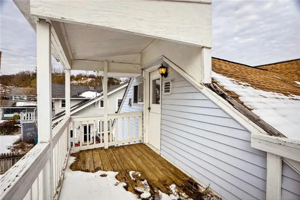a view of balcony with wooden floor and fence