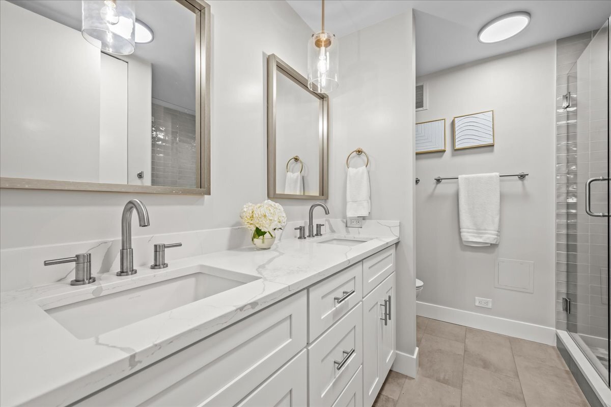 1500 Sheridan Road, Unit 3I Wilmette, IL 60091 - Photo 25 of 37 a bathroom with double vanity sink a mirror and a shower