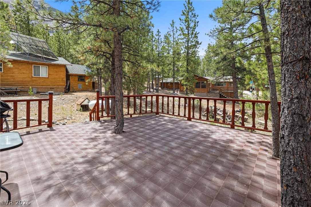 2146 Via Spes Nostra Street Mount Charleston, NV 89124 - Photo 9 of 33 A spacious tiled deck offers a peaceful retreat amidst towering pines and mountain views.