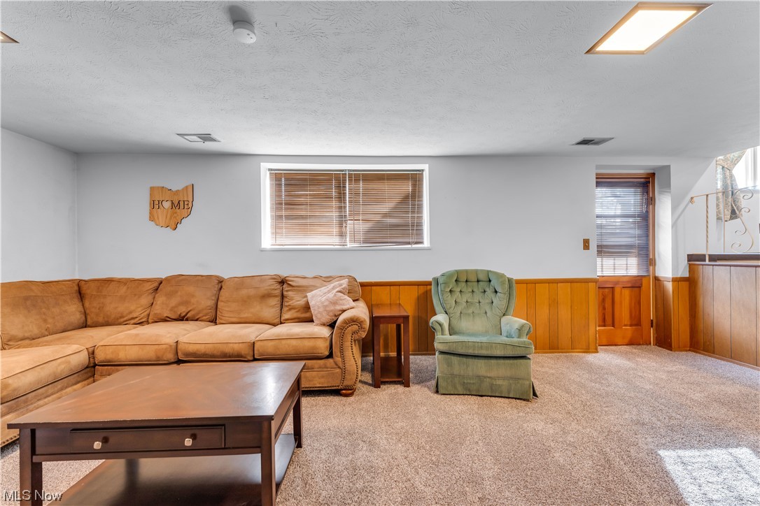 12011 Reno Drive Parma, OH 44130 - Photo 28 of 35 Carpeted living room featuring a wealth of natural light and a textured ceiling