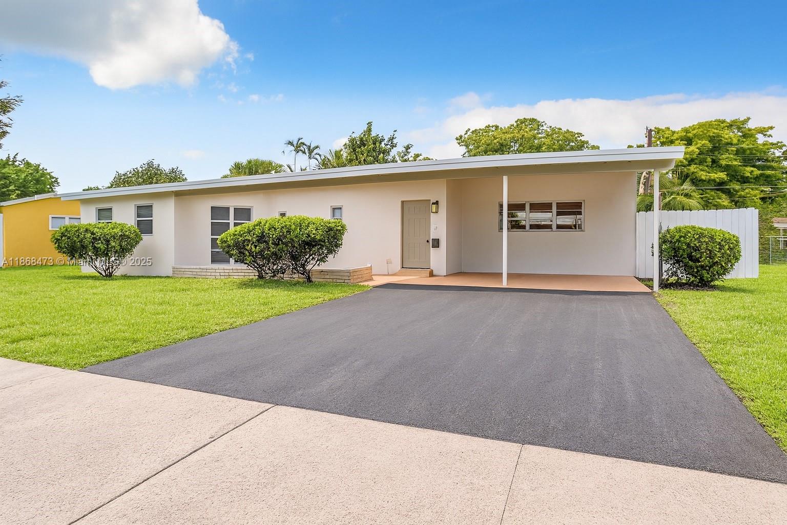 650 Northeast 178th Street Miami, FL 33162 - Photo 2 of 37 front view of a house with a yard