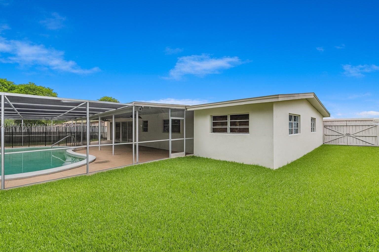 650 Northeast 178th Street Miami, FL 33162 - Photo 7 of 37 a view of a house with a backyard