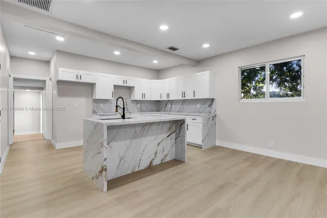 a view of kitchen with white cabinets