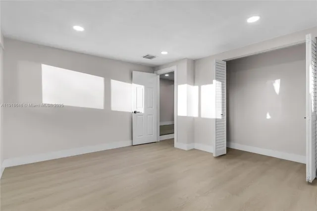 a view of kitchen with refrigerator and microwave