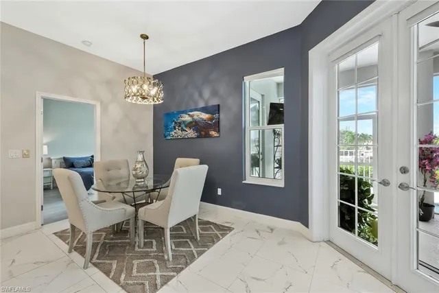 a view of a dining room with furniture and chandelier