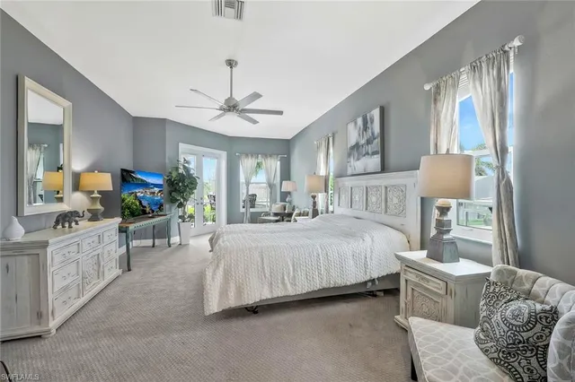 a spacious bedroom with a bed a couch and dresser