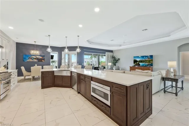 a large kitchen with a large counter top furniture a sink and a stove