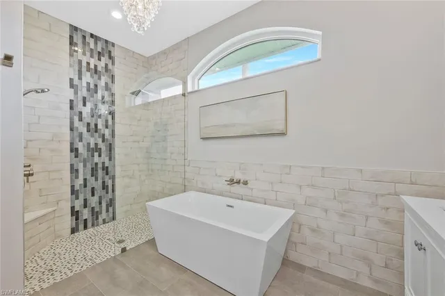 a bathroom with a white sink a shower curtain and a mirror