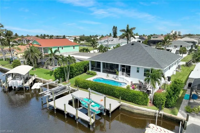 an aerial view of a house with swimming pool garden view and lake view