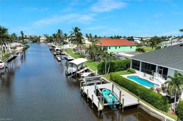 an aerial view of a house with swimming pool garden and patio