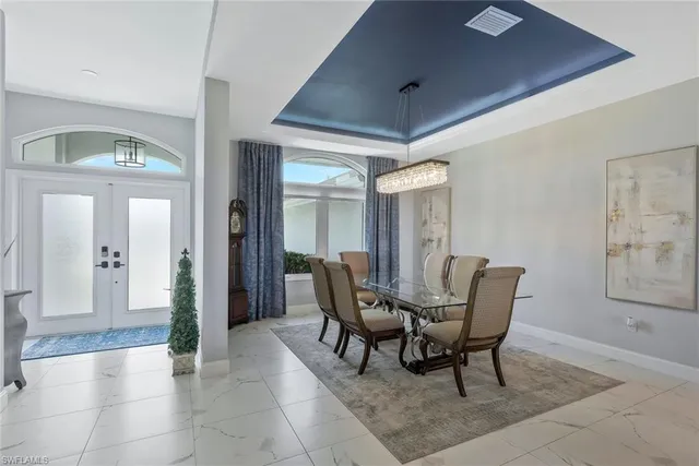 a view of a dining room with furniture and a chandelier