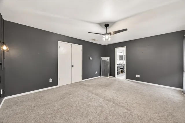 a view of an empty room with a ceiling fan