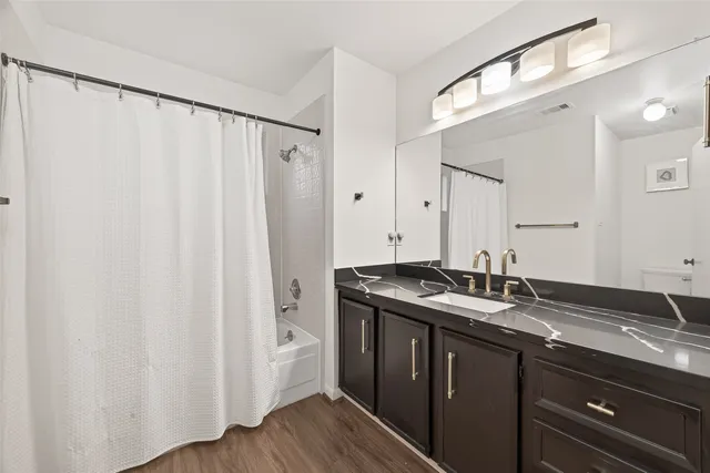 a bathroom with a double vanity sink and mirror