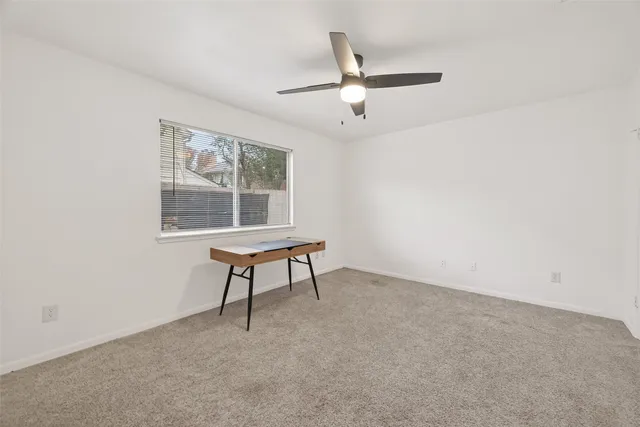 a room with a window and a ceiling fan