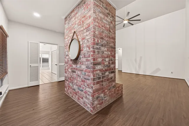 a room with a wooden floor and a chandelier