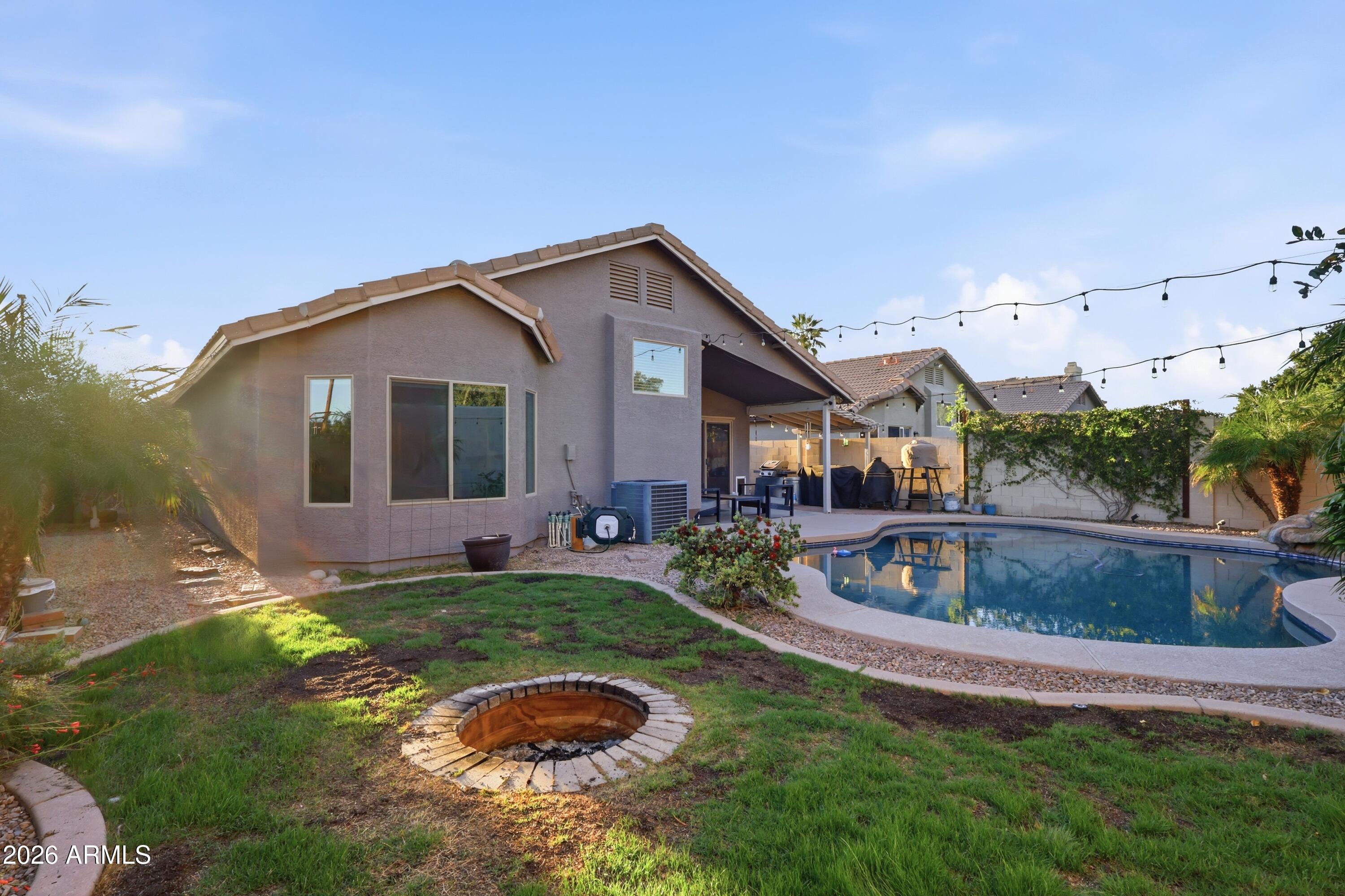 661 North Joshua Tree Lane Gilbert, AZ 85234 - Photo 32 of 47 a view of a house with a swimming pool