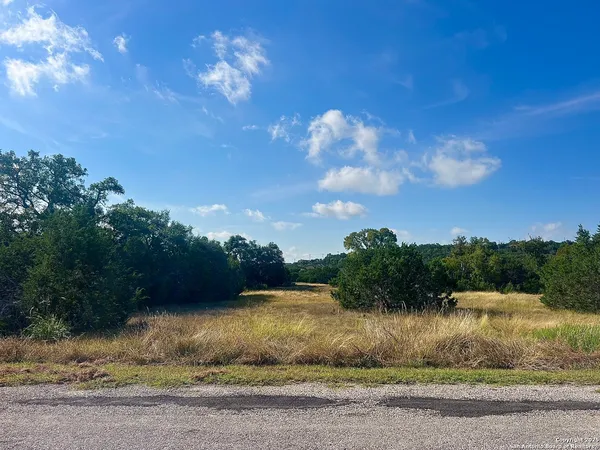 a view of a lake with a yard
