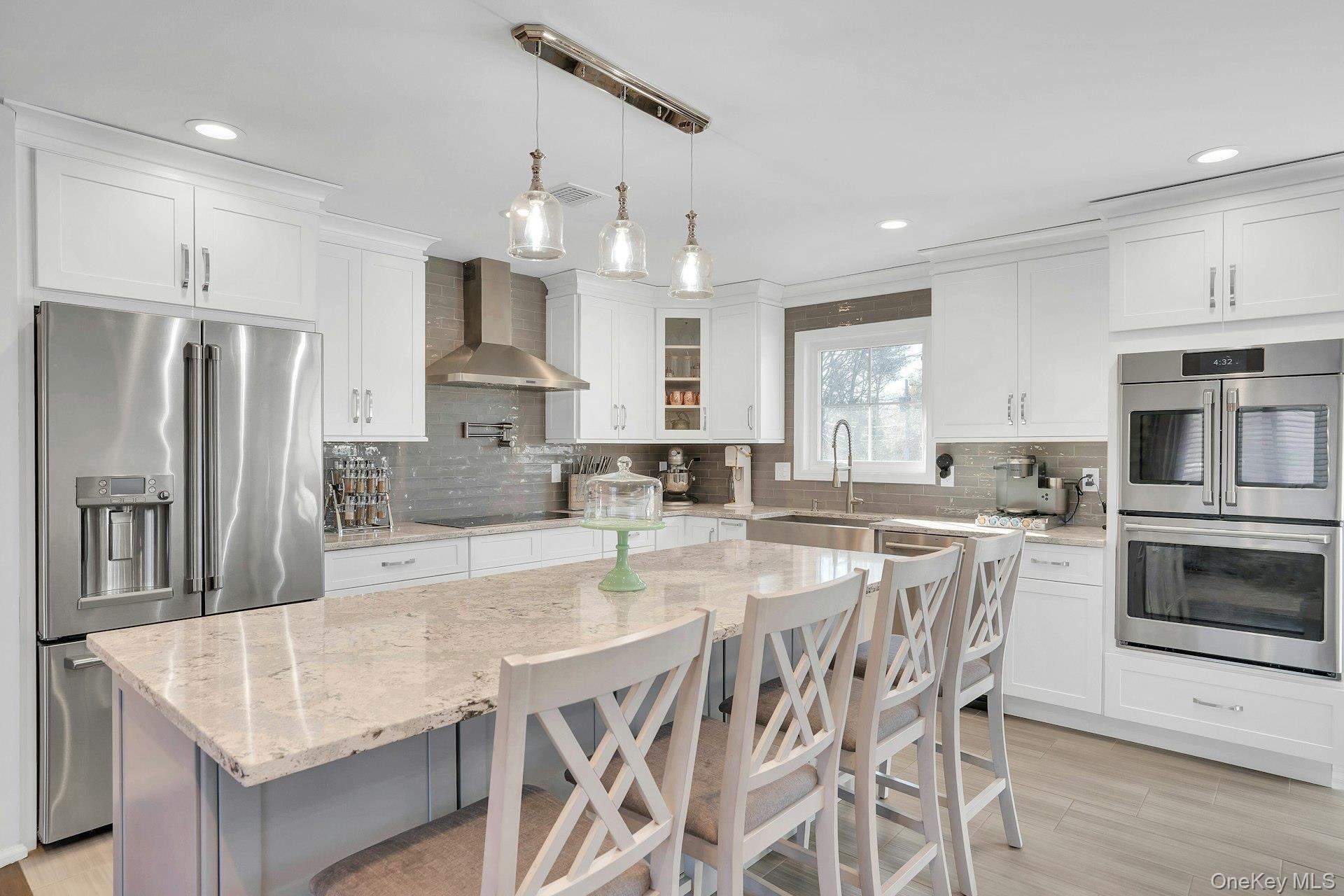 108 Hayrick Lane Commack, NY 11725 - Photo 12 of 50 a kitchen with stainless steel appliances granite countertop a table chairs sink refrigerator and microwave