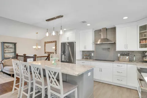 a kitchen with stainless steel appliances kitchen island granite countertop a sink and cabinets
