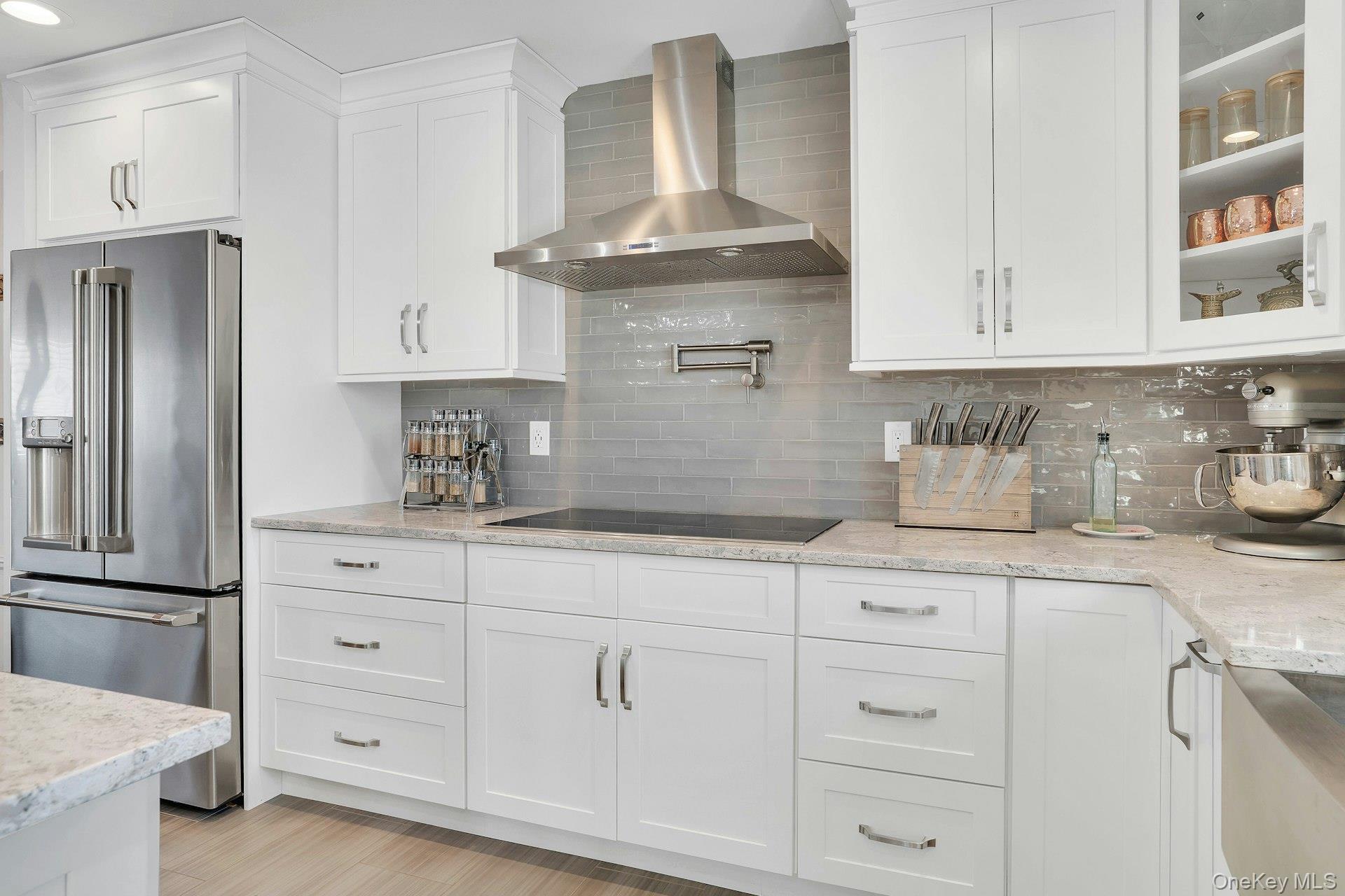 108 Hayrick Lane Commack, NY 11725 - Photo 15 of 50 a kitchen with white cabinets and refrigerator