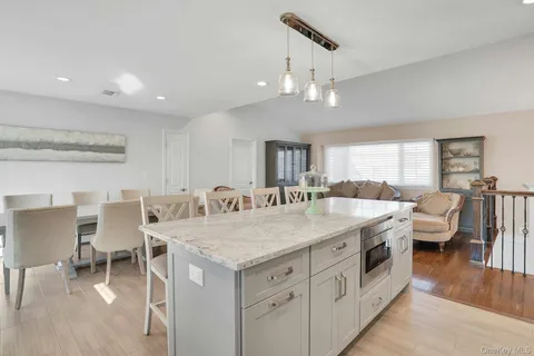 a kitchen with stainless steel appliances kitchen island granite countertop a sink and cabinets