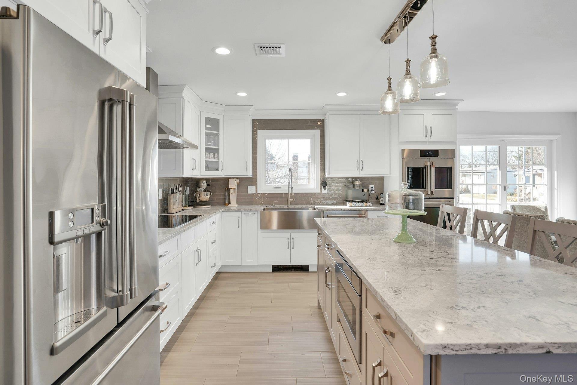 108 Hayrick Lane Commack, NY 11725 - Photo 18 of 50 a large kitchen with stainless steel appliances granite countertop a sink refrigerator and cabinets