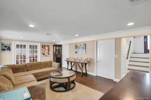 a living room with furniture a dining table and a large window