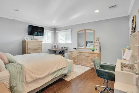 a bedroom with a bed and a television