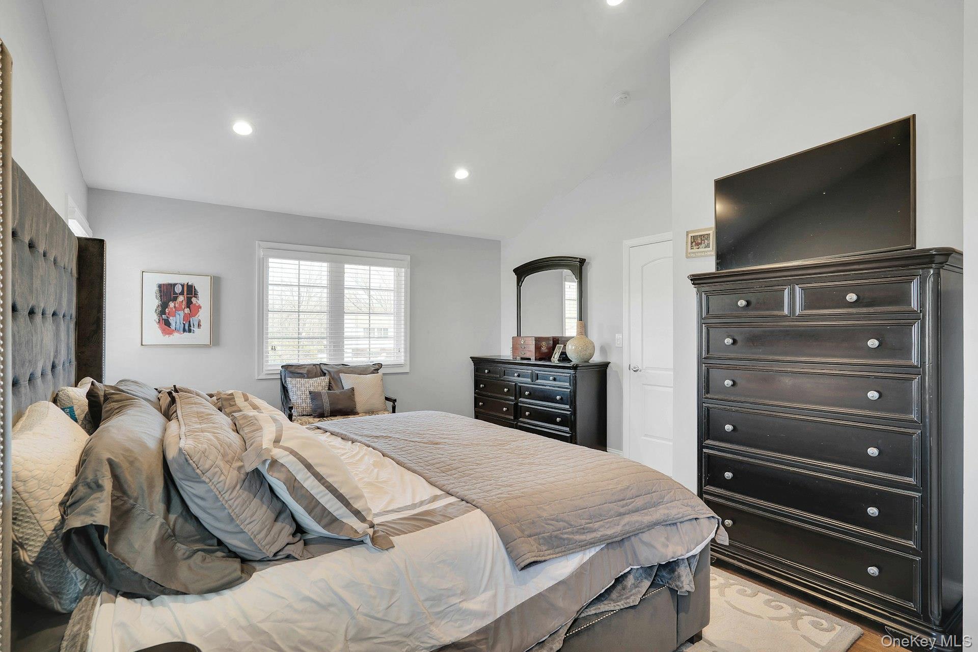 108 Hayrick Lane Commack, NY 11725 - Photo 31 of 50 a bedroom with a bed and a flat screen tv
