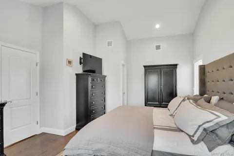 a bedroom with a bed and a television