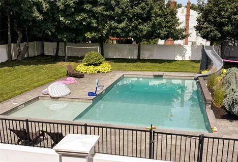 a view of a patio with a table chairs and backyard
