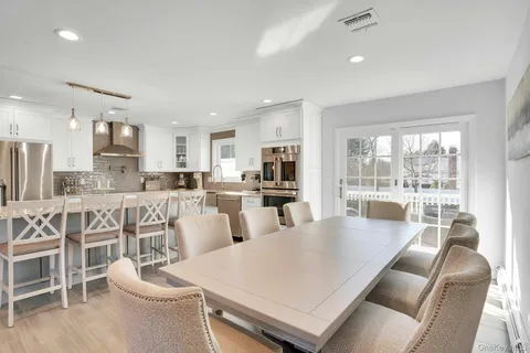 a large kitchen with a table and chairs