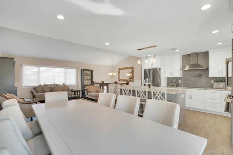 a large white kitchen with a large window