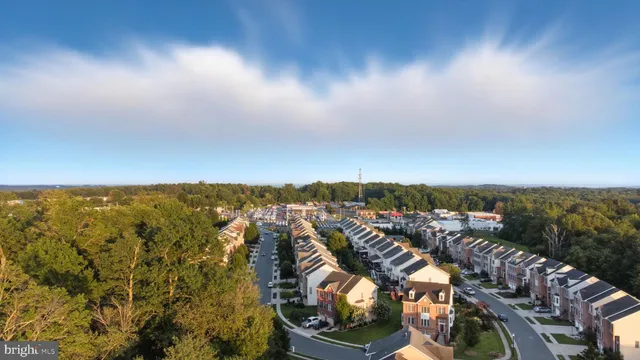 a large kitchen with stainless steel appliances kitchen island granite countertop a refrigerator and a stove top oven