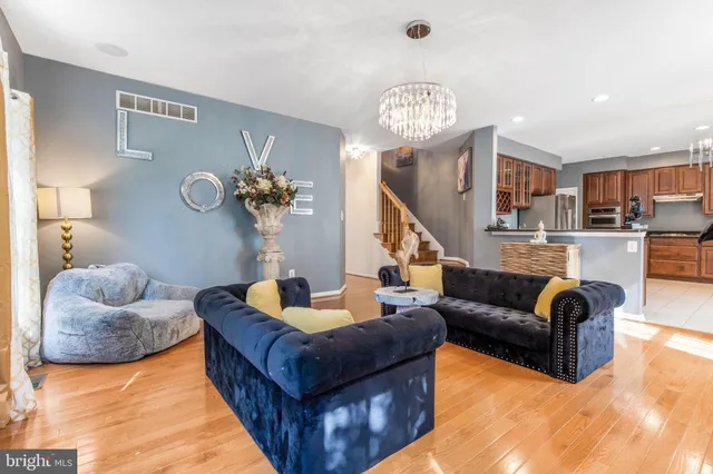 a view of an empty room with window and a fan