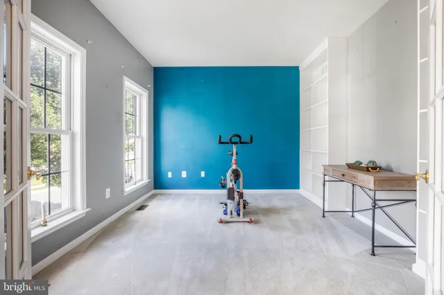 an aerial view of residential houses with outdoor space and parking