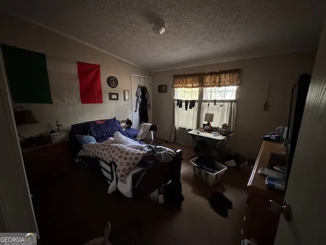 a bedroom with bed and window