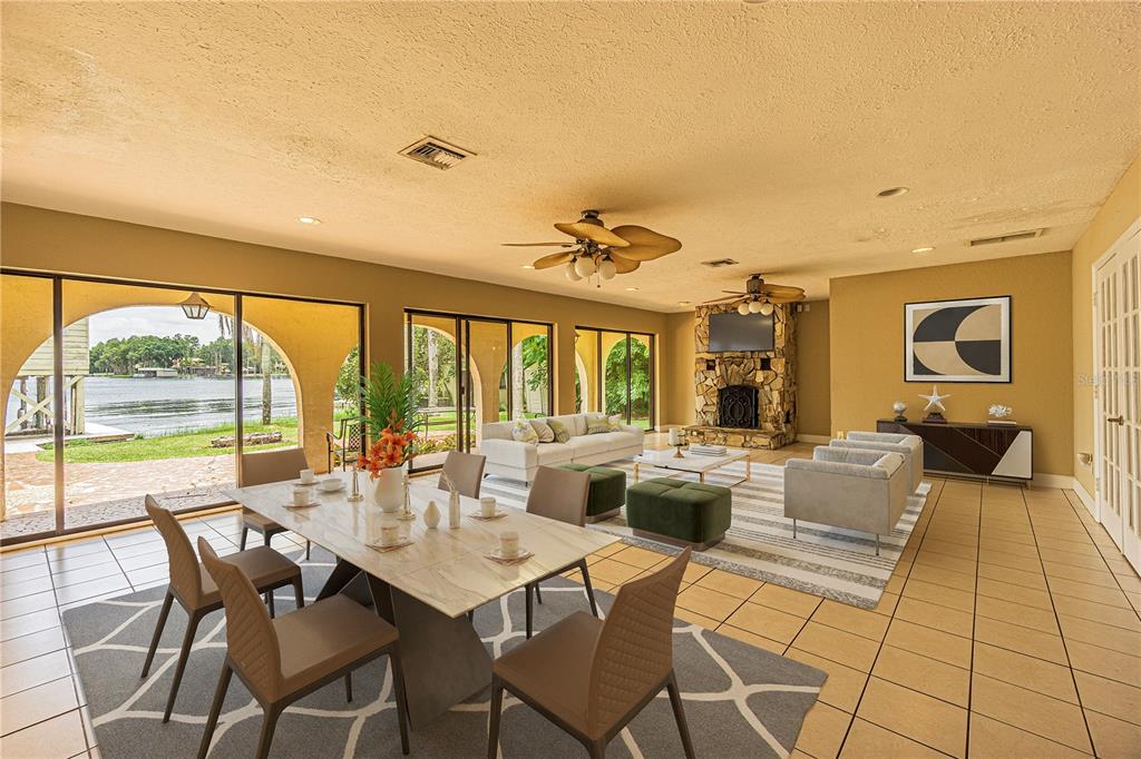 18129 Crawley Road, Unit 1 Odessa, FL 33556 - Photo 13 of 51 a view of a dining room with furniture large windows and wooden floor