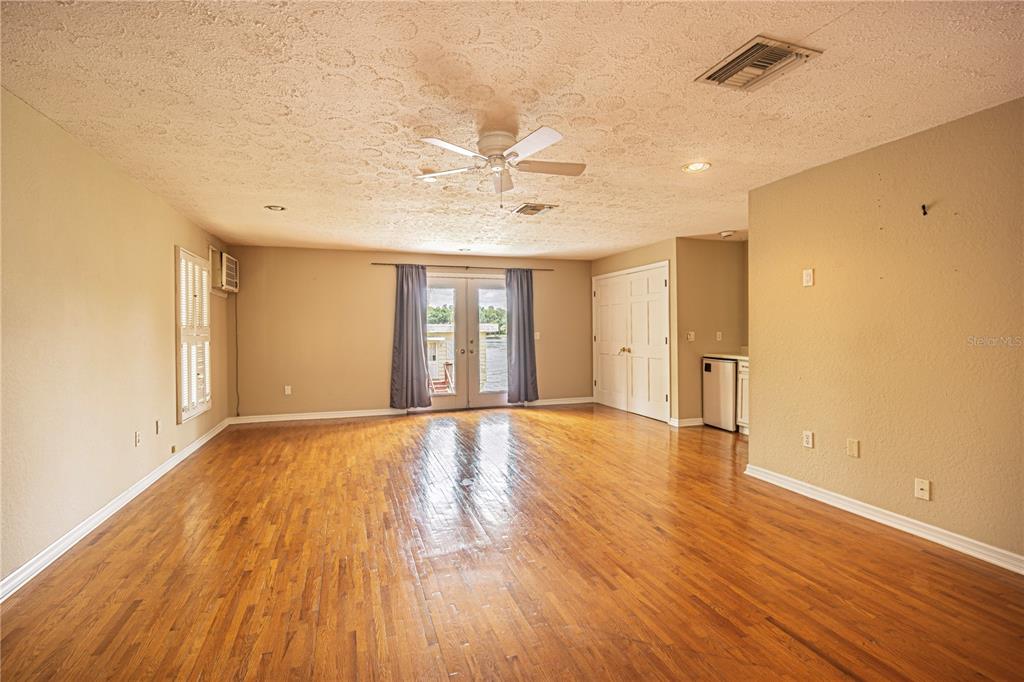 18129 Crawley Road, Unit 1 Odessa, FL 33556 - Photo 29 of 51 a view of an empty room with wooden floor and a window