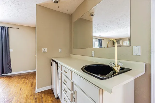 a bathroom with a granite countertop sink a toilet and a mirror