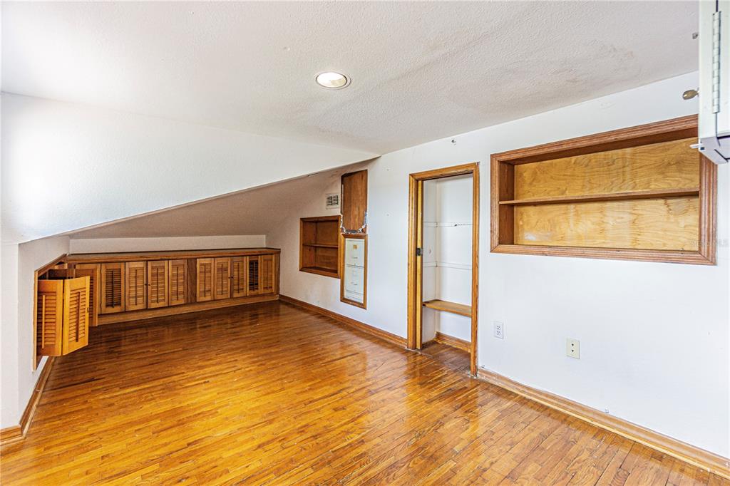 18129 Crawley Road, Unit 1 Odessa, FL 33556 - Photo 39 of 51 a view of an empty room with wooden floor and a window