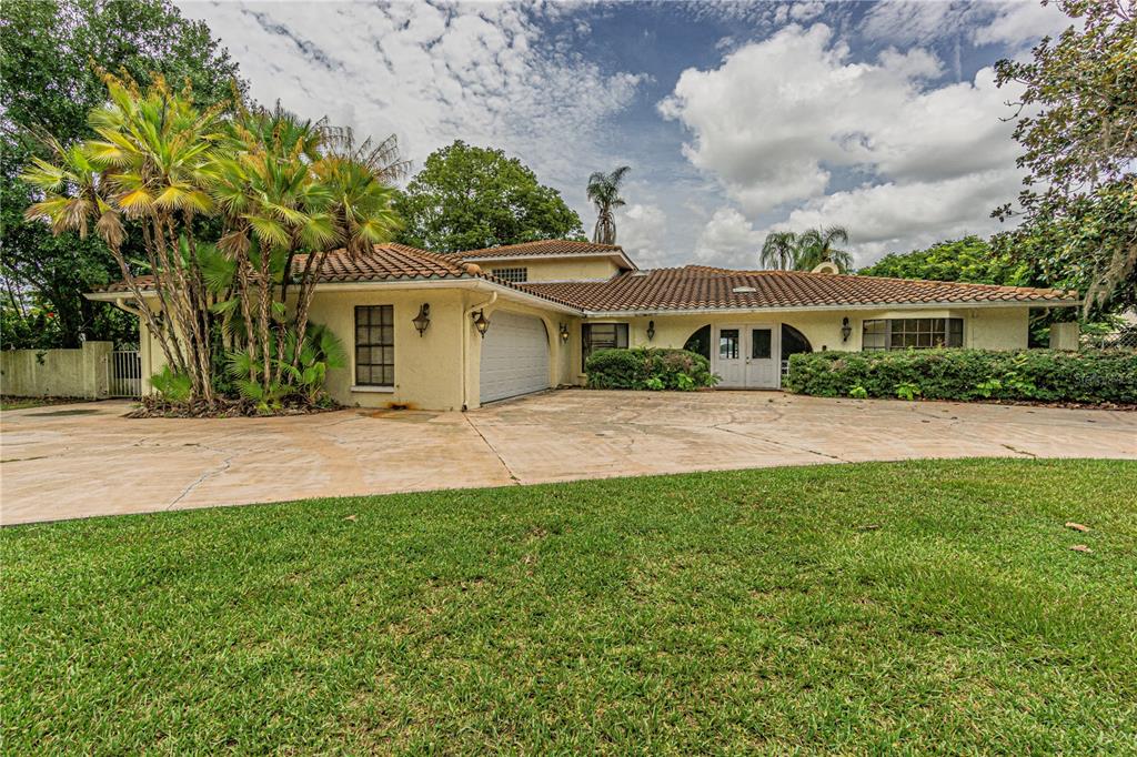 18129 Crawley Road, Unit 1 Odessa, FL 33556 - Photo 4 of 51 a front view of a house with a yard