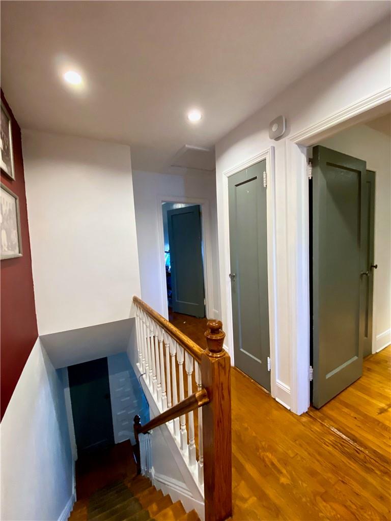 169-10 29th Avenue Queens, NY 11358 - Photo 6 of 10 a view of a hallway with wooden floor and stairs