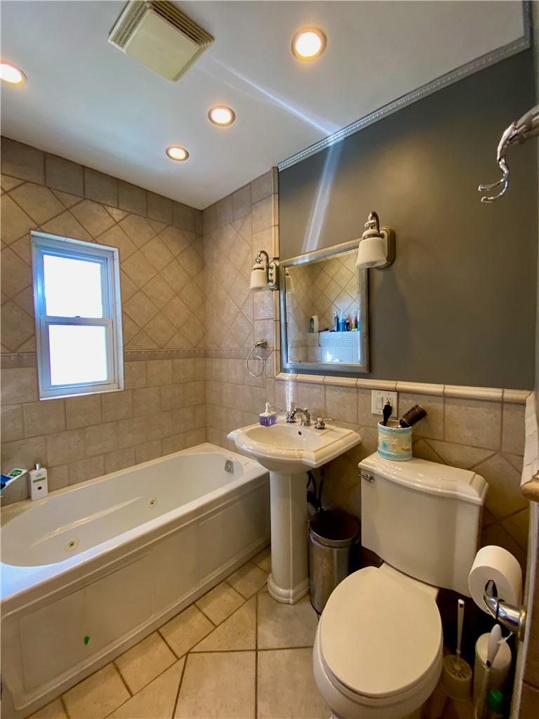 169-10 29th Avenue Queens, NY 11358 - Photo 8 of 10 a bathroom with a sink mirror toilet and bathtub